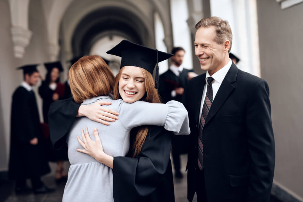 student hugging her parents