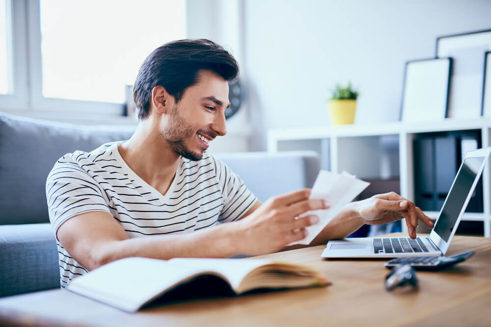 man getting out of debt paying hiss bills