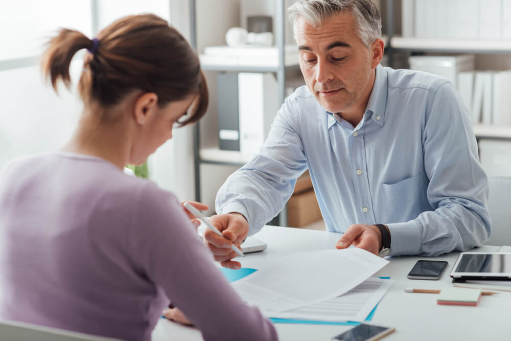 woman signing payday loan agreement